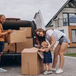 young family with little daughter moving into new house