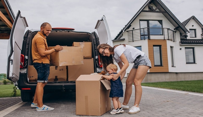 young family with little daughter moving into new house