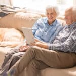 happy senior couple using digital tablet