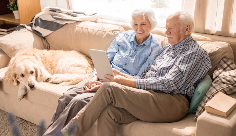 happy senior couple using digital tablet