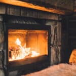 warm cozy fireplace with real wood burning in it. cozy winter concept. christmas and travel background with space for your text