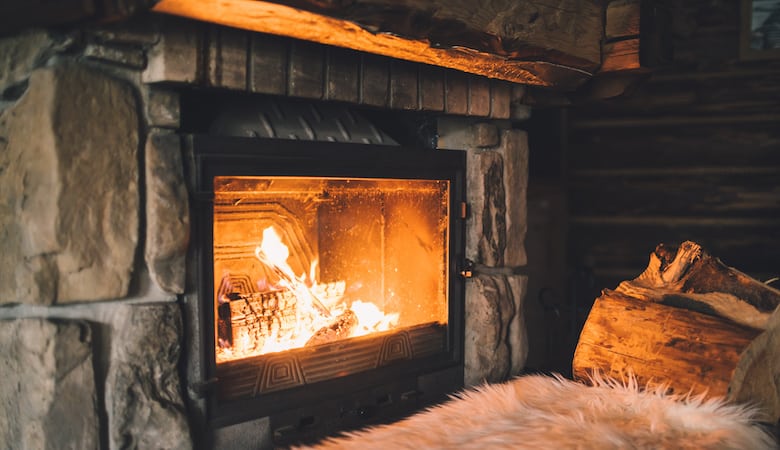 warm cozy fireplace with real wood burning in it. cozy winter concept. christmas and travel background with space for your text