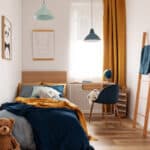 multifunctional bedroom and workspace interior with bed and desk