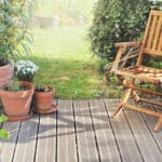 chair and potted plant on wooden terrace in summer