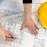 a man drawing the project of a house