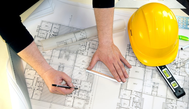 a man drawing the project of a house