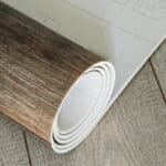 roll of linoleum with a wood texture. types of floor coverings.