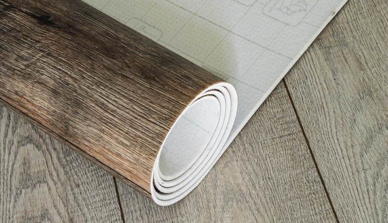 roll of linoleum with a wood texture. types of floor coverings.