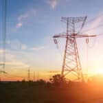 high voltage power lines at sunset. electricity distribution station .