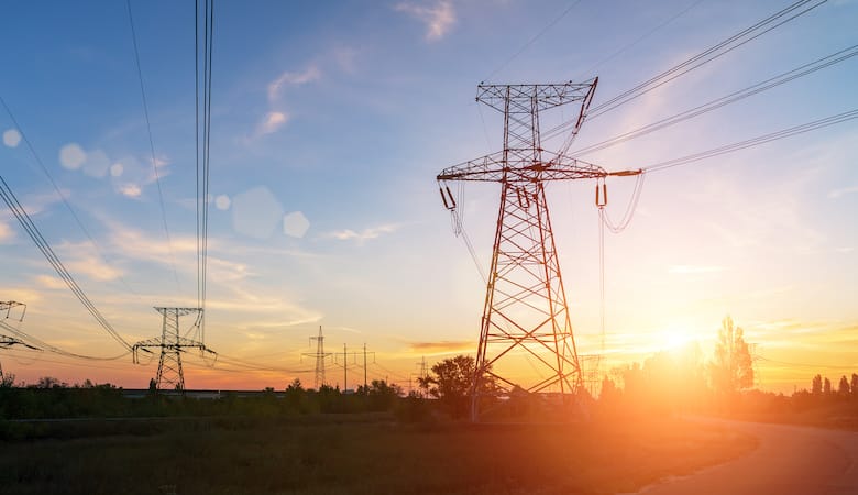 high voltage power lines at sunset. electricity distribution station .