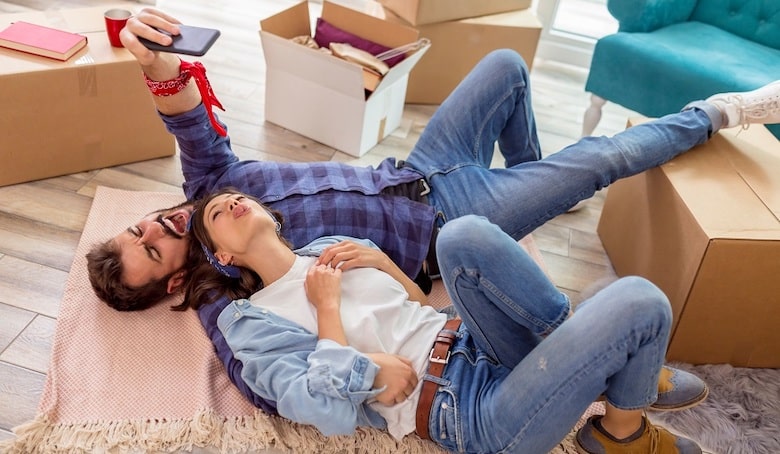 couple taking a selfie while moving in together