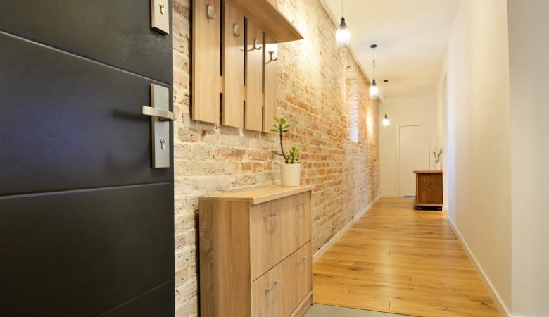 entrée d'une maison moderne. Zoom sur le couloir avec un mur en pierre et un mur blanc