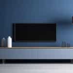 Un salon avec une TV et un meuble TV.