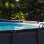 swimming pool with metal frame for home and garden. frame swimming pool in the yard. solar banner.installation of the pool. the concept of summer holidays and recreation.