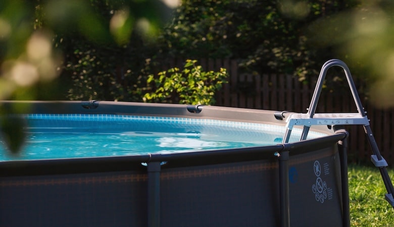 swimming pool with metal frame for home and garden. frame swimming pool in the yard. solar banner.installation of the pool. the concept of summer holidays and recreation.