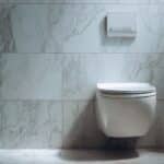 wall mounted or suspended toilet or wc in home bathroom with push button flush